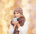 Smiling young woman in winter clothes with cup Royalty Free Stock Photo