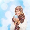 Smiling young woman in winter clothes with cup Royalty Free Stock Photo