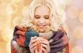 Smiling young woman in winter clothes with cup Royalty Free Stock Photo