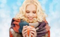 Smiling young woman in winter clothes with cup Royalty Free Stock Photo