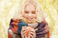 Smiling young woman in winter clothes with cup Royalty Free Stock Photo