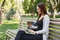 Happy young woman with laptop outdoors Royalty Free Stock Photo