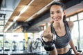 Smiling young woman working out with kettle bell in gym Royalty Free Stock Photo