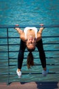 smiling young woman workout on strainght and muscular build outdoor in the city promenade by the river Royalty Free Stock Photo