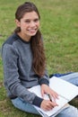 Smiling young woman writing on her notebook Royalty Free Stock Photo