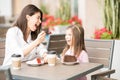 Hispanic mother and daughter on a date at restaurant Royalty Free Stock Photo