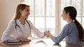 Female doctor shake hand get acquainted with patient