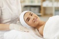 Smiling young woman looking at camera after procedure of facial massage