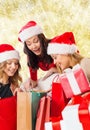 Smiling young women in santa hats with gifts Royalty Free Stock Photo