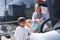 Happy family putting paper bags into car Royalty Free Stock Photo