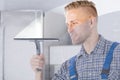 Worker Cleaning Glass Window With Squeegee Royalty Free Stock Photo