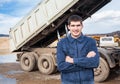 Smiling young worker and tip truck Royalty Free Stock Photo