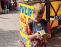 Smiling yung boy trying to solve an intelligence Rubik's Cube