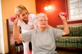 Smilinig positive senior woman enjoy in exercise with nurse Royalty Free Stock Photo