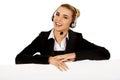 Smille call center woman holding empty banner. Royalty Free Stock Photo