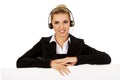 Smille call center woman holding empty banner. Royalty Free Stock Photo