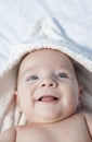 Smilling baby boy wrapped bath towel after bath in bed at home Royalty Free Stock Photo
