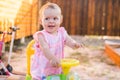 Smilling Baby girl riding toy car in garden Royalty Free Stock Photo