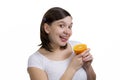 Smilling cheerfull girl licks fresh orange