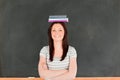 Smilling cute woman wearing books on her head Royalty Free Stock Photo