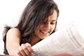 Smilling indian teen reading newspaper