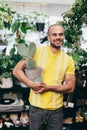 Smilling man with cactus in florist shop Royalty Free Stock Photo