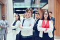 Smilling young business man in front her team blured in background. Royalty Free Stock Photo