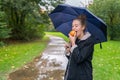 Smilling young woman eating apple outdoor