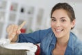 smily woman painting and renewing chair at home