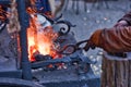 The smith is working on the horseshoe on a small forge furnace. Royalty Free Stock Photo