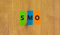 SMO, social media optimization symbol. Concept word SMO - social media optimization on colored papers on beautiful wooden Royalty Free Stock Photo