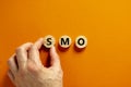 SMO, social media optimization symbol. Concept word SMO - social media optimization on wooden circles on beautiful orange Royalty Free Stock Photo