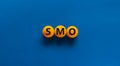 SMO, social media optimization symbol. Concept word SMO - social media optimization on yellow tennis table on beautiful blue Royalty Free Stock Photo