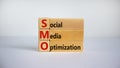 SMO, social media optimization symbol. Wooden cubes and blocks with words SMO - social media optimization on beautiful white Royalty Free Stock Photo