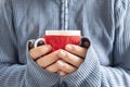 Smocked mug with hot drink in male hands. Cold season concept. Royalty Free Stock Photo