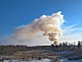 Smoke billowing from a controlled fire at a landfill site in winter in Minnesota