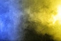 Smoke in blue yellow light on black background Royalty Free Stock Photo