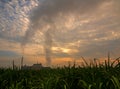 Smoke from the boiler stack and the vapor from a cooling tower in the power plant Royalty Free Stock Photo