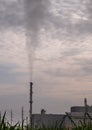 Smoke from the boiler stack and the vapor from a cooling tower in the power plant Royalty Free Stock Photo