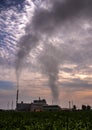 Smoke from the boiler stack and the vapor from a cooling tower in the power plant Royalty Free Stock Photo