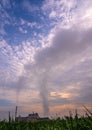 Smoke from the boiler stack and the vapor from a cooling tower in the power plant Royalty Free Stock Photo