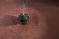 Smoke from burning incense sticks on brown decorative background Royalty Free Stock Photo