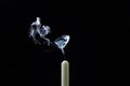 Smoke from a candle on a black background. An extinguished candle on a dark background. Royalty Free Stock Photo