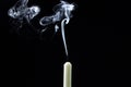 Smoke from a candle on a black background. An extinguished candle on a dark background. Royalty Free Stock Photo
