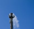 Smoke from the chimney of a chemical plant against the blue sky. The problem of environmental pollution. Ecology concept Royalty Free Stock Photo