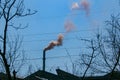 Smoke from the chimney of a chemical plant against the blue sky. The problem of environmental pollution. Ecology concept Royalty Free Stock Photo