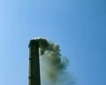 Smoke from the chimney of a chemical plant against the blue sky. The problem of environmental pollution. Ecology concept Royalty Free Stock Photo