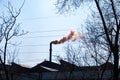 Smoke from the chimney of a chemical plant against the blue sky. The problem of environmental pollution. Ecology concept Royalty Free Stock Photo