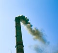 Smoke from the chimney of a chemical plant against the blue sky. The problem of environmental pollution. Ecology concept Royalty Free Stock Photo