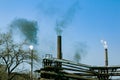 Smoke from the chimney of a chemical plant against the blue sky. The problem of environmental pollution. Ecology concept Royalty Free Stock Photo